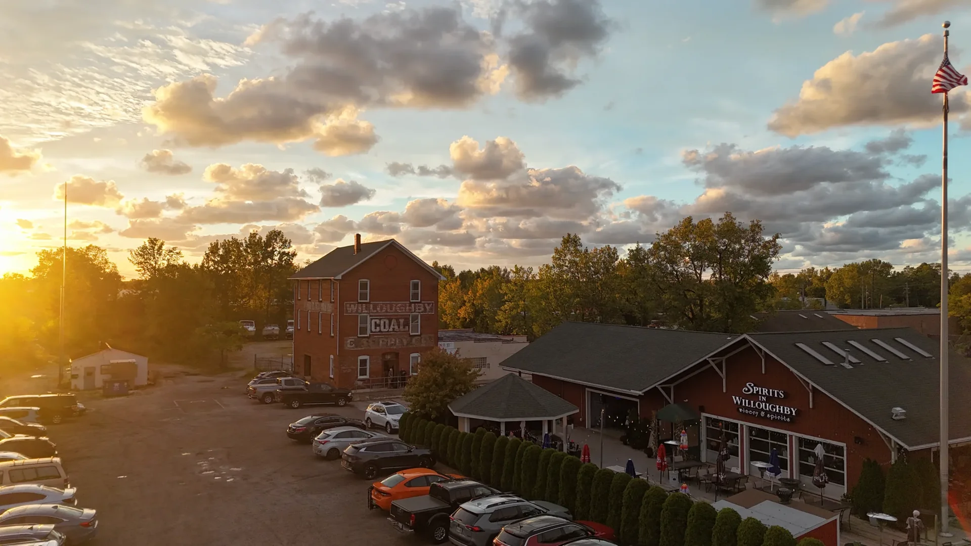 Aerial view at sunset of the historic Willoughby Coal building beside Spirits in Willoughby on Erie Street