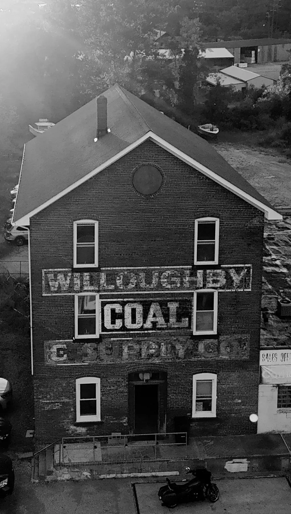 Black-and-white aerial view of the Willoughby Coal & Supply Co. brick façade