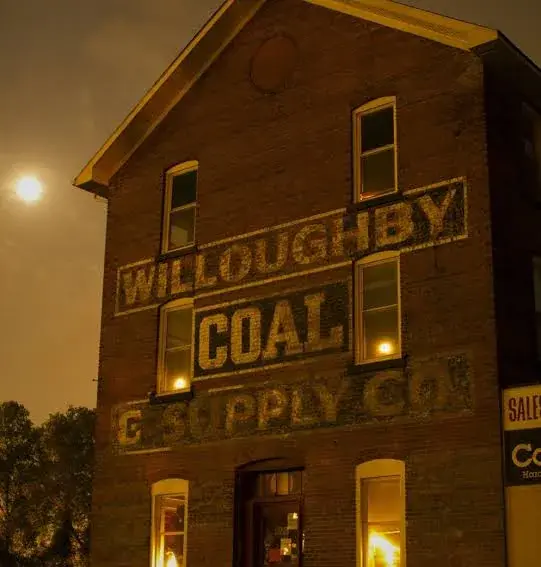 Nighttime view of the Willoughby Coal building with lit windows